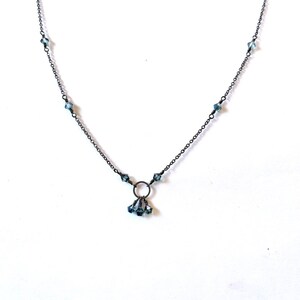 Circular charm necklace with hanging iridescent Czech crystals in delicate gunmetal grey chain