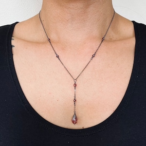 Pale burgundy crystal drop necklace on delicate gunmetal grey chain