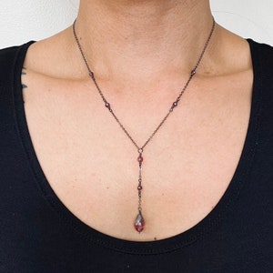 Pale burgundy crystal drop necklace on delicate gunmetal grey chain