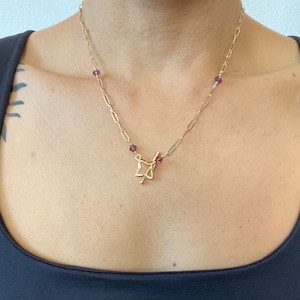 Variety of toggle clasp necklaces on large link gold chains with crystal/stone accents
