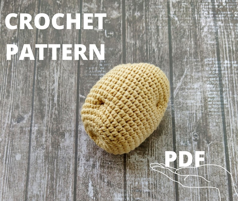 May include: Crochet pattern for a beige potato shaped amigurumi toy. The pattern is available as a PDF download. The image shows the finished crocheted potato on a wooden background.