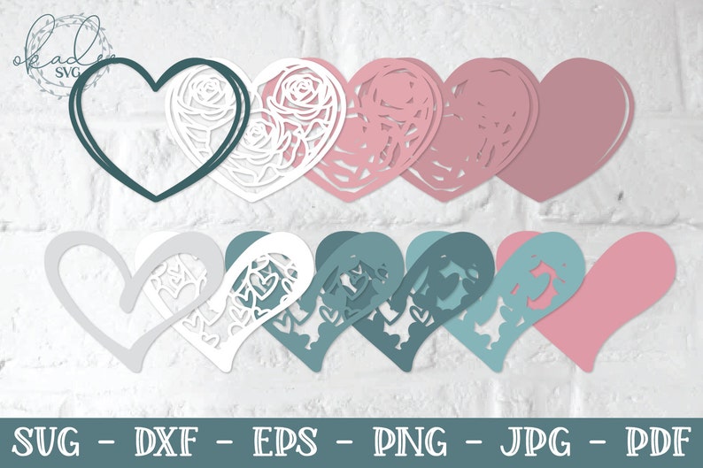 Pu&ograve; includere: Un set di 10 sagome di carta a forma di cuore sovrapposte con un design floreale. I cuori sono in tonalit&agrave; di rosa, grigio, bianco e verde acqua.