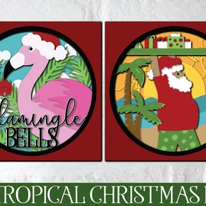 May include: Two 3D paper cut-out designs for Christmas. The first design features a pink flamingo wearing a Santa hat with the text "flamingle bells". The second design features Santa Claus wearing a red shirt and green pants, holding a tray of presents with the text "ho ho ho".