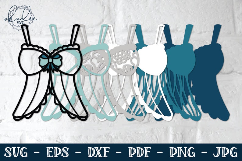 May include: A digital cut file design of a bra with a bow, in black and white, with multiple layers in shades of blue and gray.  The design is labeled "SVG - EPS - DXF - PDF - PNG - JPG".