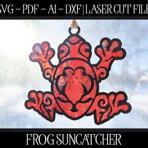 May include: A red frog suncatcher with a black outline, cut from a laser file. The frog has an intricate design with swirls and patterns. The text "SVG - PDF - AI - DXF | LASER CUT FILE" is at the top, and "FROG SUNCATCHER" is at the bottom.
