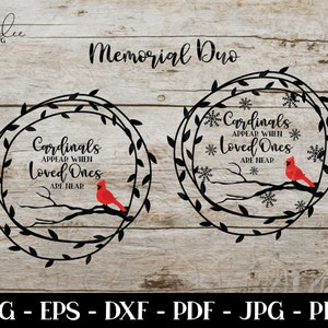 May include: Two black wreaths with a red cardinal bird on a branch inside each wreath. The wreaths have the text "Cardinals Appear When Loved Ones Are Near" inside each wreath.