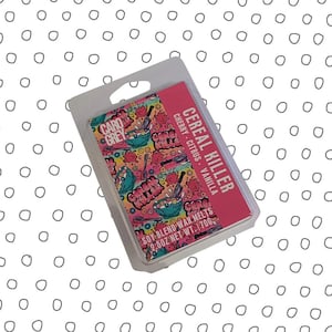 May include: A package of soy blend wax melts with the text "CEREAL KILLER" and "CARO GREY". The packaging features a colorful design with cereal bowls and the scent notes "CHERRY CITRUS VANILLA". The net weight is 2.5oz.