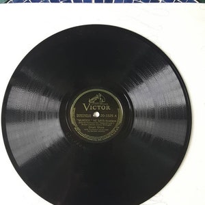 May include: A black vinyl record with a gold label. The label has the text "Victor" and "20-1525 A" and the song title "Murder He Says - Vocalese" by Dinah Shore.