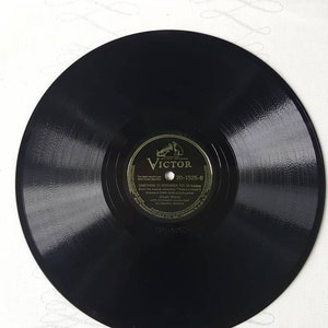May include: Black vinyl record with a gold label featuring the Victor logo and the text "Something to Remember You By" by  Gordon Jenkins from the musical production "There's a  Clown" (Howard Dietz-Arthur Schwartz) with Gordon Jenkins and his Orchestra with  Gordon Jenkins. The record number is 20-1525-B.