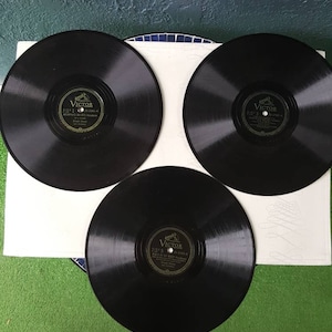 May include: Three black vinyl records with gold labels. Each label features the Victor logo and the text "Victor" and "His Master's Voice".