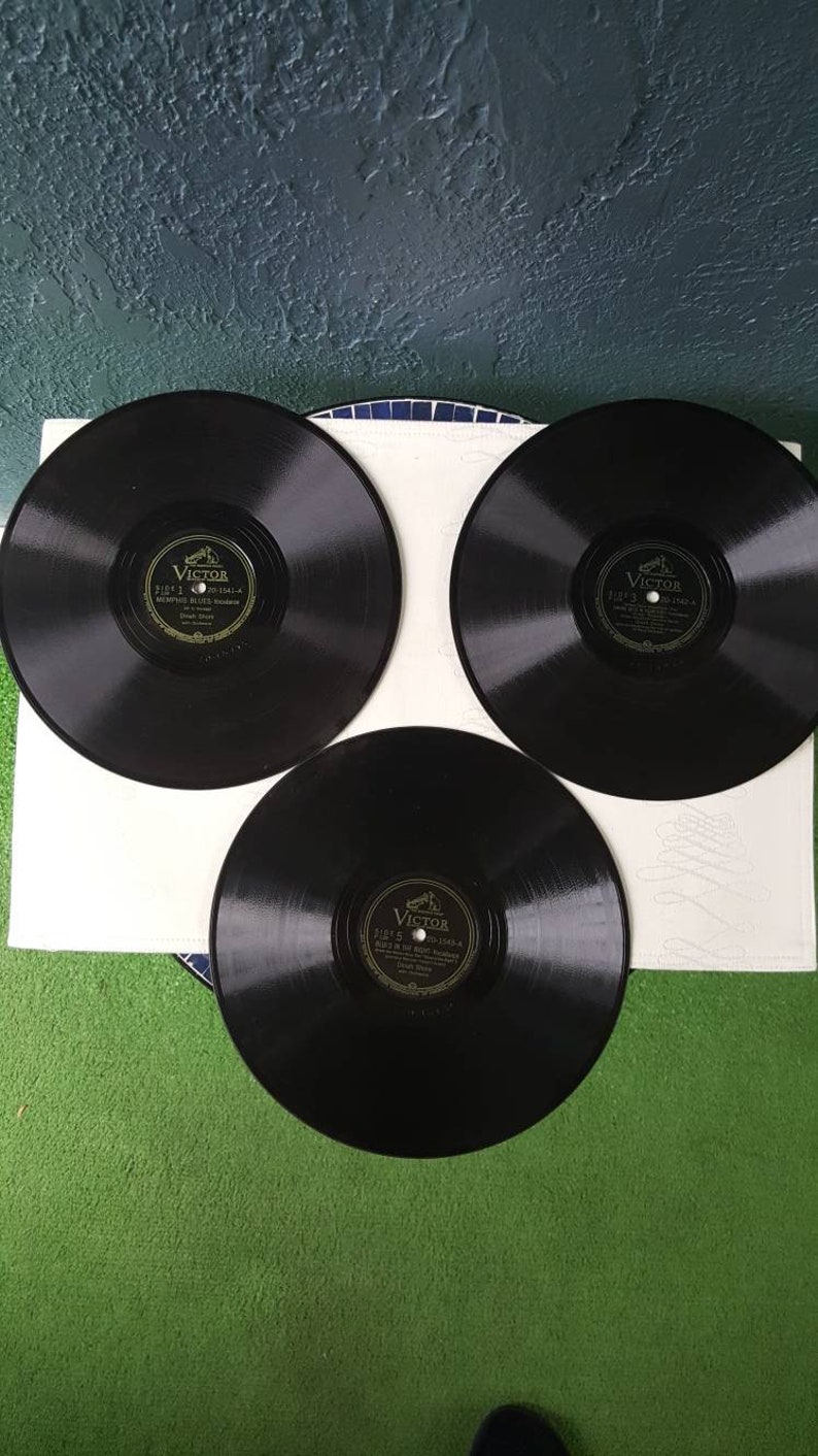 May include: Three black vinyl records with gold labels. Each label features the Victor logo and the text "Victor" and "His Master's Voice".