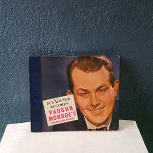 May include: A vintage vinyl record album cover featuring a smiling man in a suit. The album is titled "Vaughn Monroe's Dreamland Special" and is a RCA Victor Records release.