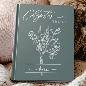 May include: A sage green hardcover book featuring white line art of a floral bouquet. The cover displays the text Chapter THIRTY in a mix of script and serif fonts, with the name bree written in script inside a white horizontal frame.