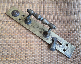 An old large antique doorknob, late 19th century brand. Antique brass. Vintage door bronze handle door handle with a keyhole. Antique bronze