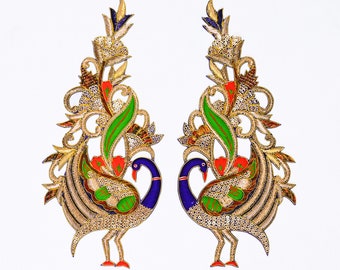 May include: Two gold embroidered peacock appliques with blue, green, and red details. The peacocks are facing opposite directions and have intricate floral designs.