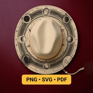 May include: A cream-colored hat with a wide brim featuring a black celestial design of moons and suns. The hat has a tan leather band and a cream-colored crown. The text "PNG • SVG • PDF" is in a yellow rectangle.
