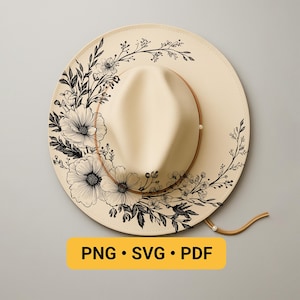 May include: A cream-colored fedora-style hat with a wide brim, adorned with a black floral design. The hat features a brown leather band and a chin strap. The text "PNG • SVG • PDF" is displayed on a yellow rectangle.