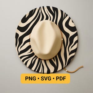 May include: A beige fedora hat with a black and white zebra print brim. The hat has a brown leather band and a chin strap. The image includes the text "PNG • SVG • PDF" in a yellow rectangle.