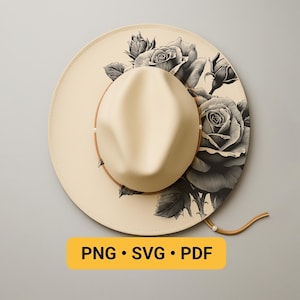 May include: A cream-colored fedora-style hat with a wide brim, adorned with a black and white rose floral design. The hat features a brown leather band and a matching chin strap. The text "PNG • SVG • PDF" is displayed on a yellow rectangle.