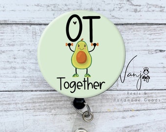 May include: A green and yellow avocado cartoon character with a heart on its head, holding dumbbells, with the text "OT Together" on a white background. The image is on a round badge with a black retractable badge holder.