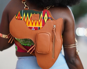 May include: A brown leather crossbody bag with a colorful patterned flap and a small zippered pocket. The bag is shaped like the continent of Africa.