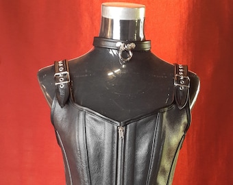 Female Black Leather full length Corset with front Zip and shoulder strap detail, fully boned and lined with purple silky lining .