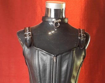 Female Black Leather full length Corset with front Zip and shoulder strap detail, fully boned and lined with purple silky lining .