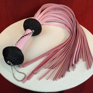 Heavy Leather Baby Pink Flogger with black handle knob detailed.