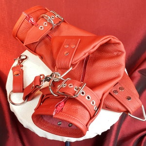 Red leather hand mitten set with leather wrist belts.