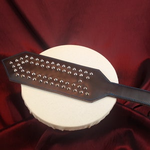 Heavy Leather broad Paddle with silver studs.