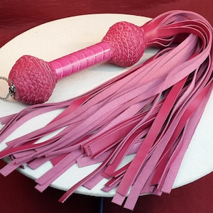 Candy Pink Leather Flogger with Ostrich Handle Detail.