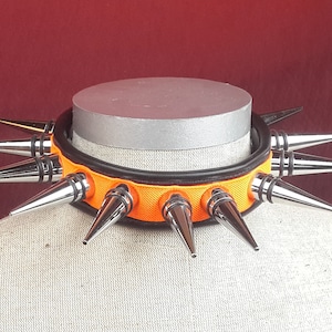 Leather Collar with 11 Cone Spikes and orange inlay.