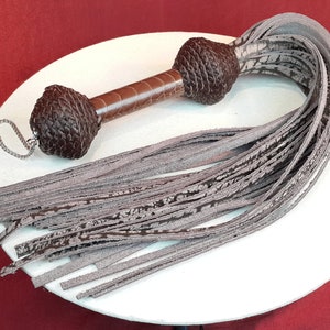 Buffalo hide Flogger with Ostrich handle detail.