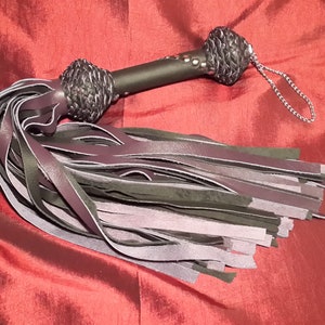 Leather Flogger in purple and black leather.