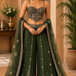 May include: A dark green ensemble consisting of a sweetheart neckline corset top with a multi-colored intricate pattern and matching wide-leg trousers. The trousers feature gold embroidery and a sheer, floor-length dupatta with gold border detailing.