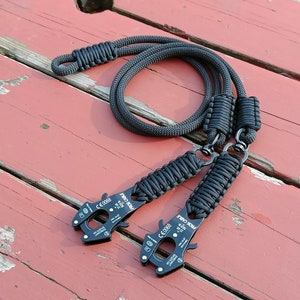 May include: Two black paracord lanyards with black metal clips. The clips have the text "PRO-TOOL" and "CE 0088" printed on them.