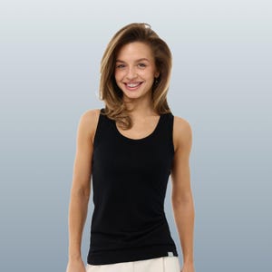 May include: A black tank top with a scoop neck. The sleeveless top is made of a soft material. The model is smiling and wearing the tank top. The background is a gradient of blue and white.