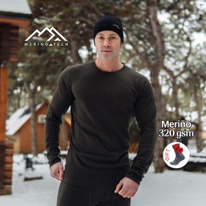 May include: A dark olive green long-sleeve crew neck shirt and matching pants, paired with a black beanie featuring a white mountain logo. The text Merino Tech is visible, along with a graphic of socks labeled Merino 320 gsm.