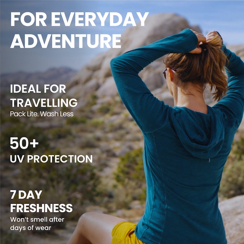 May include: A person wearing a teal hooded long-sleeve shirt and yellow shorts. The text on the image reads: "FOR EVERYDAY ADVENTURE", "IDEAL FOR TRAVELLING", "50+ UV PROTECTION", and "7 DAY FRESHNESS". The background shows a rocky landscape.