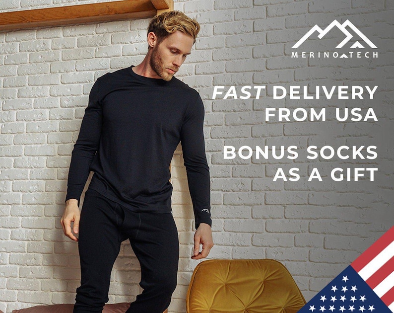 May include: A man wearing a black long-sleeve shirt and black pants. The text "FAST DELIVERY FROM USA BONUS SOCKS AS A GIFT" is displayed on a white brick wall background. The image also includes a small American flag in the bottom right corner.