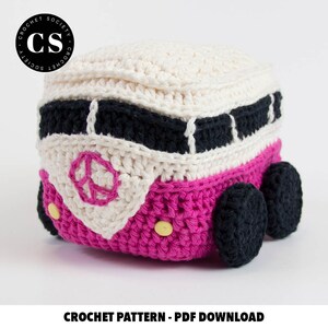 May include: Crochet pattern for a pink and white VW bus with black details. The pattern includes instructions for crocheting the bus, wheels, and peace sign.  "CROCHET PATTERN - PDF DOWNLOAD" is written below the bus.