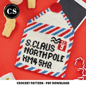 May include: Crochet pattern for a Santa Claus mailbag with red, white, and blue stripes. The mailbag has the text "S. Claus North Pole KM4 SHQ" on it.