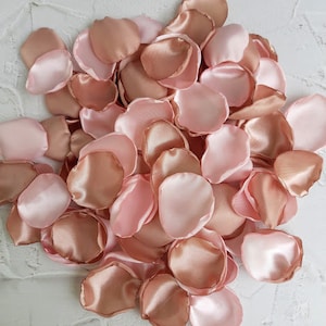 May include: A pile of rose petals in shades of pink and peach. The petals are made of satin and are perfect for weddings, parties, or other special occasions.