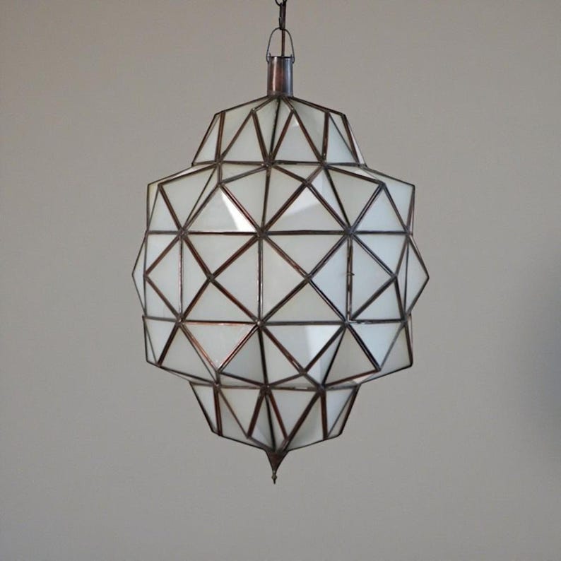 Geometric pendant lamp with white panels and dark metal framework.