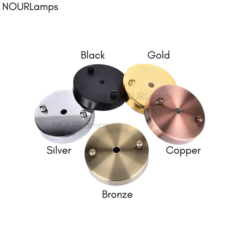 May include: Five ceiling light fixture canopy covers in different finishes: black, gold, silver, copper, and bronze.