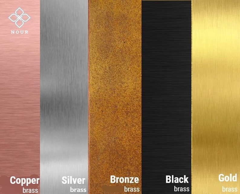 May include: Five metal samples in different colors: copper, silver, bronze, black, and gold. Each sample has a brushed finish and the word "brass" is written below each sample.