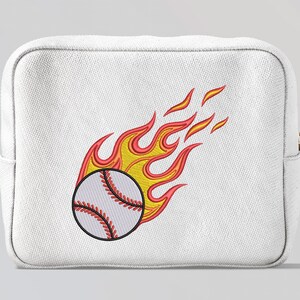 May include: A white cosmetic bag with an embroidered design of a baseball on fire. The baseball has red stitching, and the flames are yellow and red.