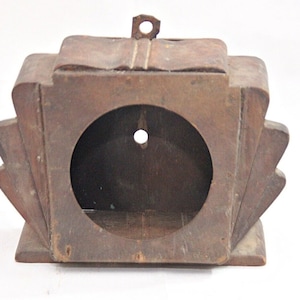 May include: A wooden clock face with a decorative, geometric design. The clock face is unfinished and has a hole in the center for the clock hands.