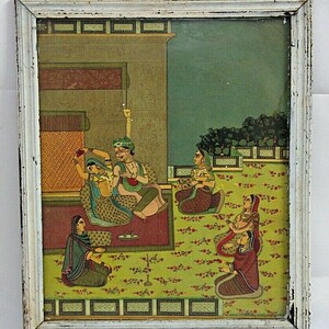 May include: A framed painting depicting a scene of a royal couple with their attendants. The painting is done in a traditional Indian style with vibrant colors and intricate details. The couple is seated on a platform, surrounded by their attendants who are offering them gifts and paying their respects. The background features a palace with a lush garden.