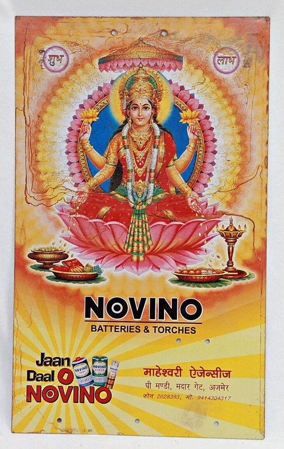 Vintage Novino Battery Goddess Lakshmi Advertising Tin Sign Board – Retro Litho Print Wall Art, Unique Collectible Decor for Home or Office
